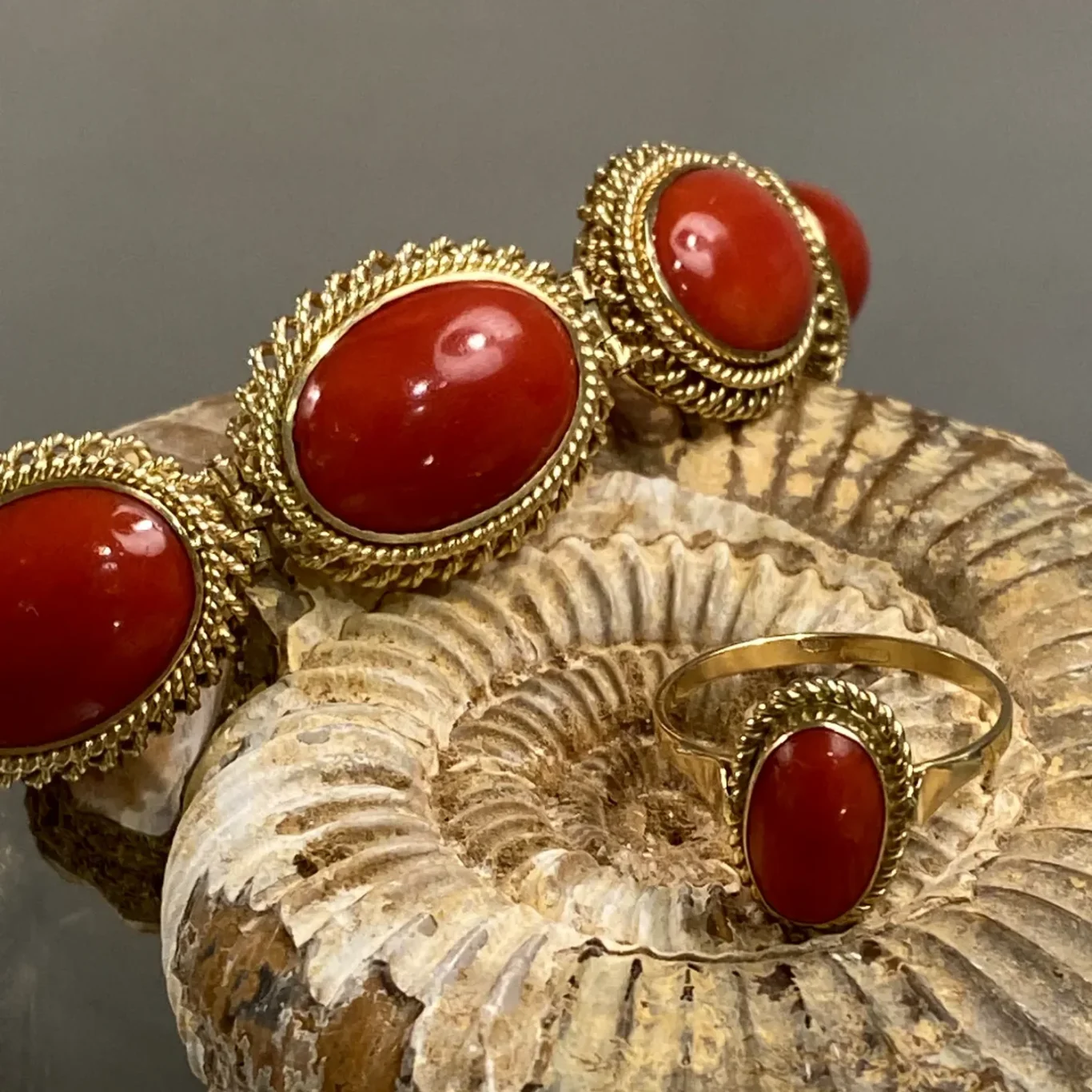 Goldring mit ovalem, roséfarbenem Stein in glatter Fassung.