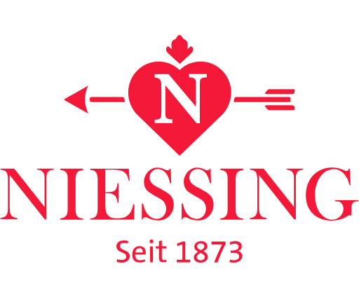 Logo NIESSING Logo von Niessing mit Herzsymbol und Pfeil, gegründet 1873.