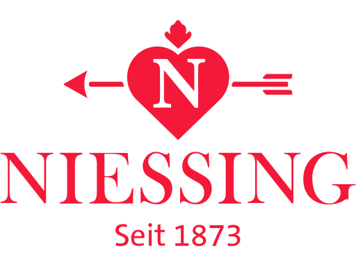 Rotes Logo von Niessing mit Herz, Pfeil und der Inschrift „Seit 1873“.